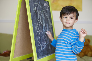 Boy drawing on blackboard