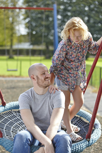 Dad and daughter on swing together