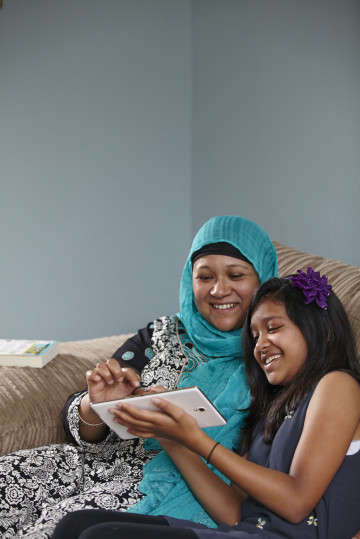 mum and girl looking at a tablet