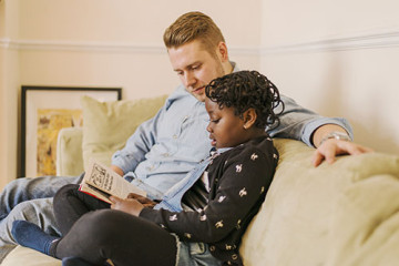 Daughter reading to Dad