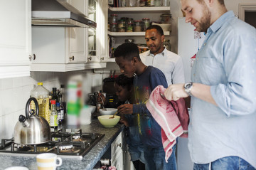 Same sex couple with son and daughter in the kitchen