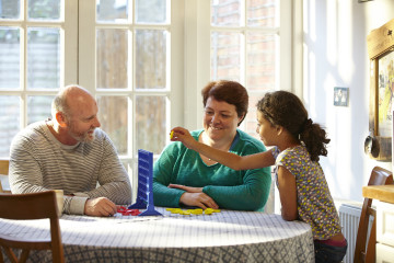 Mum, dad and daughter playing a game