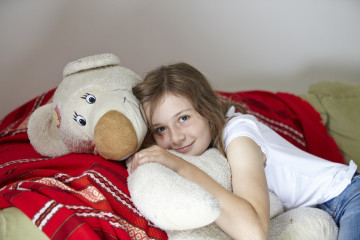 Girl cuddles bear