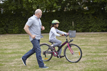 Dad with daughter on bike