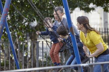 Family playing on swings
