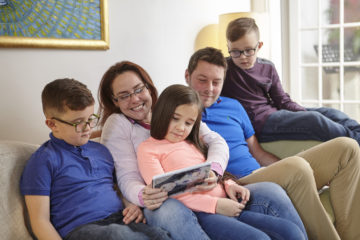 Family playing game on the tablet